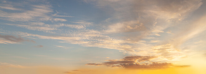 Sky background. Sky with white cumulus and orange sunlight