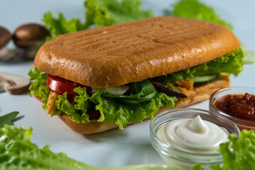 Ciabatta panini sandwich with chicken and vegetables sauce, salad, mushrooms. isolated on white background. Concept for the production of fast food bread. Bakery products. Close-up. Selective focus