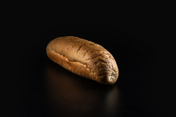 Hot dog bread, bun without ingredients. Concept for the production of baked goods for fast food. isolated on black background. Copy space.