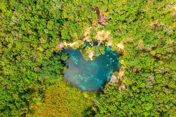 Heart shaped cenote in the middle of a jungle in Tulum, Mexico. Beautiful heart in nature. Romantic love style concept.