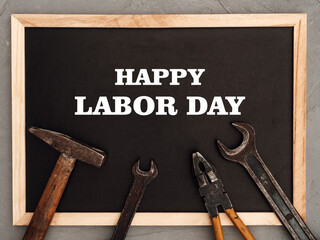 LABOR DAY. Hand tools lying on the table. View from above, close-up. Preparing for the celebration. Congratulations to loved ones, family, relatives, friends and colleagues. National holiday concept