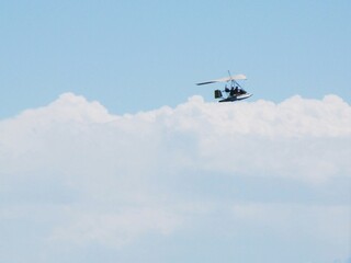 Fototapeta na wymiar An airplane flies against the background of clouds