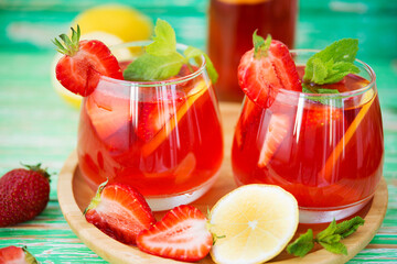 Homemade strawberry lemonade on a rustic background, a refreshing summer drink
