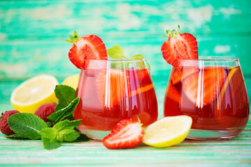 Homemade strawberry lemonade on a rustic background, a refreshing summer drink