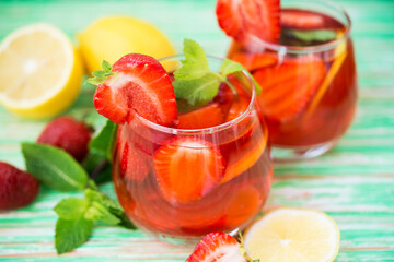 Fototapeta na wymiar Homemade strawberry lemonade on a rustic background, a refreshing summer drink