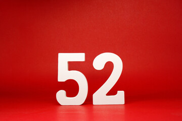 Fifty Two ( 52 ) white number wooden Isolated Red Background with Copy Space - New promotion 52%...