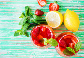 Homemade strawberry lemonade on a rustic background, a refreshing summer drink
