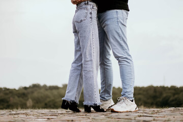 Young couple kissing outdor.  Couple kissing outdor.. Male and female legs during a date