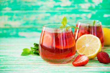 Homemade strawberry lemonade on a rustic background, a refreshing summer drink