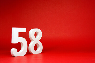 Fifty Eight ( 58 ) white number wooden on Red Background with Copy Space - New promotion 58% Percentage , Birthday anniversary , Business finance Concept 