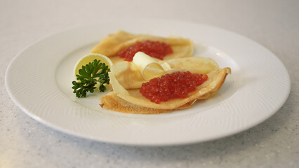 Russian pancakes with caviar and butter
