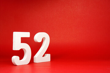 Fifty Two ( 52 ) white number wooden Isolated Red Background with Copy Space - New promotion 52%...