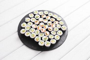 Set of sushi rolls on black plate