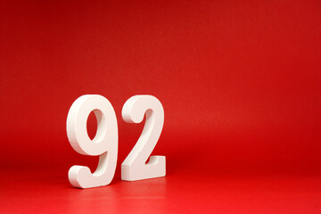 Ninety Two ( 92 ) white number wooden on Red Background with Copy Space - New promotion 92% Percentage , Birthday anniversary , Business finance Concept 