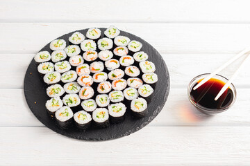 Set of sushi rolls on black plate
