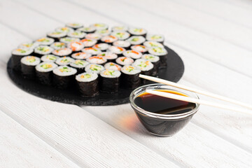 Set of sushi rolls on black plate