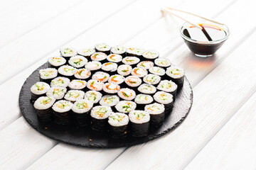 Set of sushi rolls on black plate
