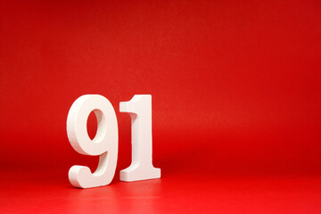 Ninety One ( 91 ) white number wooden Isolated Red Background with Copy Space - New promotion 91%...