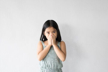 Asian child or kid girl sick and sneezing or cold cough with hand close mouth and nose to influenza...