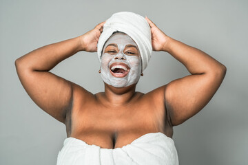 Happy curvy African woman having skin care spa day - Healthy beauty clean treatment and youth...