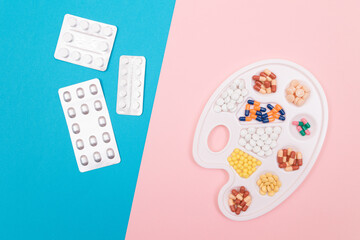Global Pharmaceutical Industry and Medicinal Products - Different Colored Pills, Tablets and Capsules on White Art Palette with Pill Packages Lying on Split Blue and Pink Background, Flat Lay