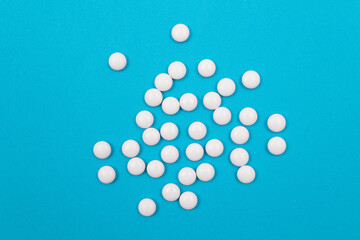 Global Pharmaceutical Industry and Medicinal Products - White Pills on Blue Background