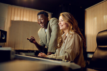 Two engineers at mixing console, recording studio
