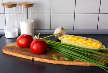 corn  on the cob, tomatoes and harvest in the kitchen