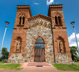 Front view of rectangular plan, two-tower church with Neo-Gothic features of the Romantic period fence stone masonry.