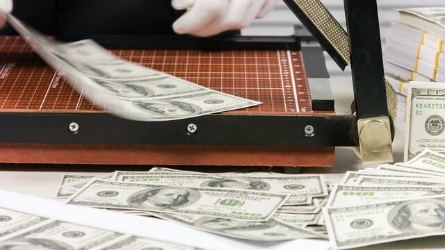 illegal manufactory of money, close up cutter and counterfeit money.