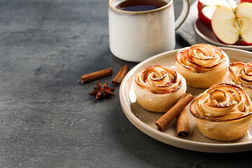 Freshly baked apple roses on grey table. Beautiful dessert