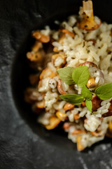 chanterelle risotto in a black plate