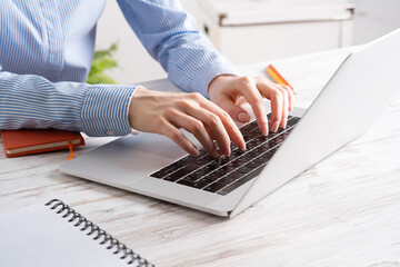 Close up business woman hands working at laptop