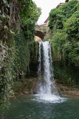Waterfall under an ancient stone bridge at Tobera, near Frias, Merindades, Burgos, Spain.Leisure...