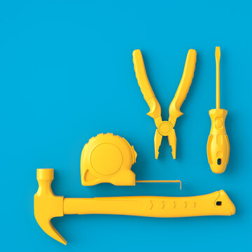 Top view of monochrome construction tools for repair on blue and yellow