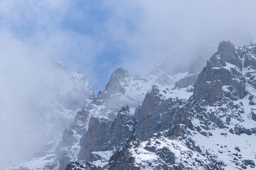 Rocky peaks in snow and fog