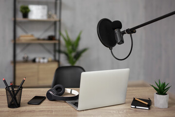 home studio desk with microphone and laptop for recording and streaming