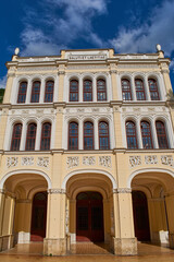 Wide angle view of Baile Herculane Casino with blue sky in background