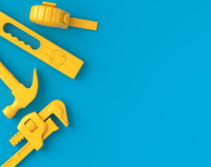 Top view of monochrome construction tools for repair on blue and yellow