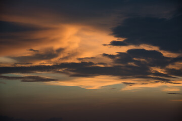 Fototapeta na wymiar Beautiful, stunning golden sky during the sunset at Promthep Cape landmark viewpoint in Phuket