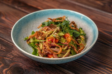 Delicious salad with boiled beef tongue, cucumber