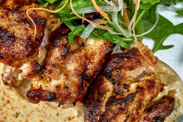 Grilled beef with white barbecue sauce ponzu cucumbers and sauce in a plate on a wooden background
