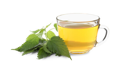 Glass cup of aromatic nettle tea and green leaves on white background