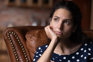 Indifferent lonely 30s woman lost in thoughts, looking away, feeling frustration, tiredness,...