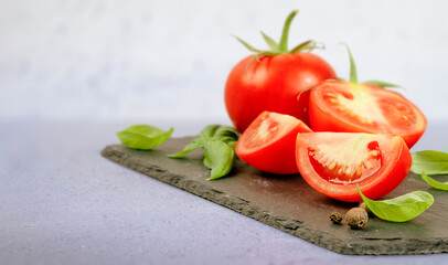 chopped tomato and basil leaves on the table