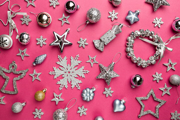 Christmas holidays composition with silver christmas decorations and snowflakes on pink background with copy space for your text