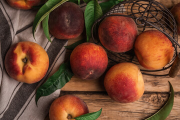 Fototapeta na wymiar Fresh ripe juicy peaches on wooden table, flat lay