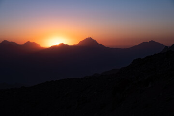 colorful sunset on the top of fann moutains.