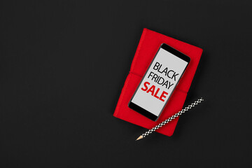 Flat lay top view mockup with smartphone and note pad. Black friday sale