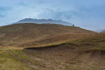 Mountains in the fog. Fall. Overcast. Ile-Alatau mountains, Almaty region, Kazakhstan.